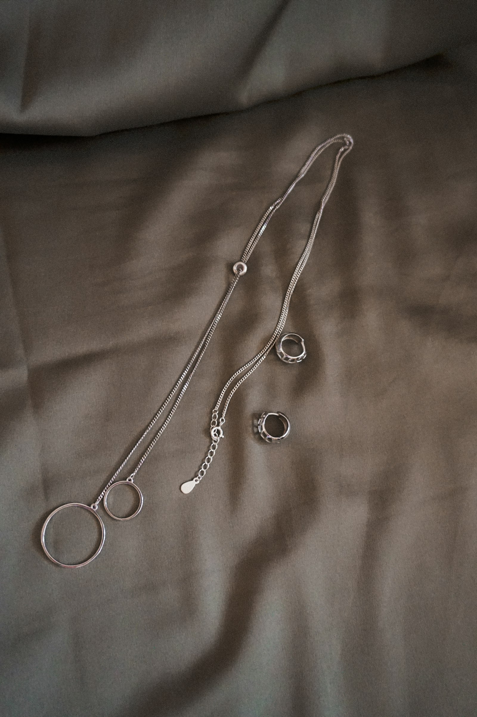 Sterling silver necklace on soft linen