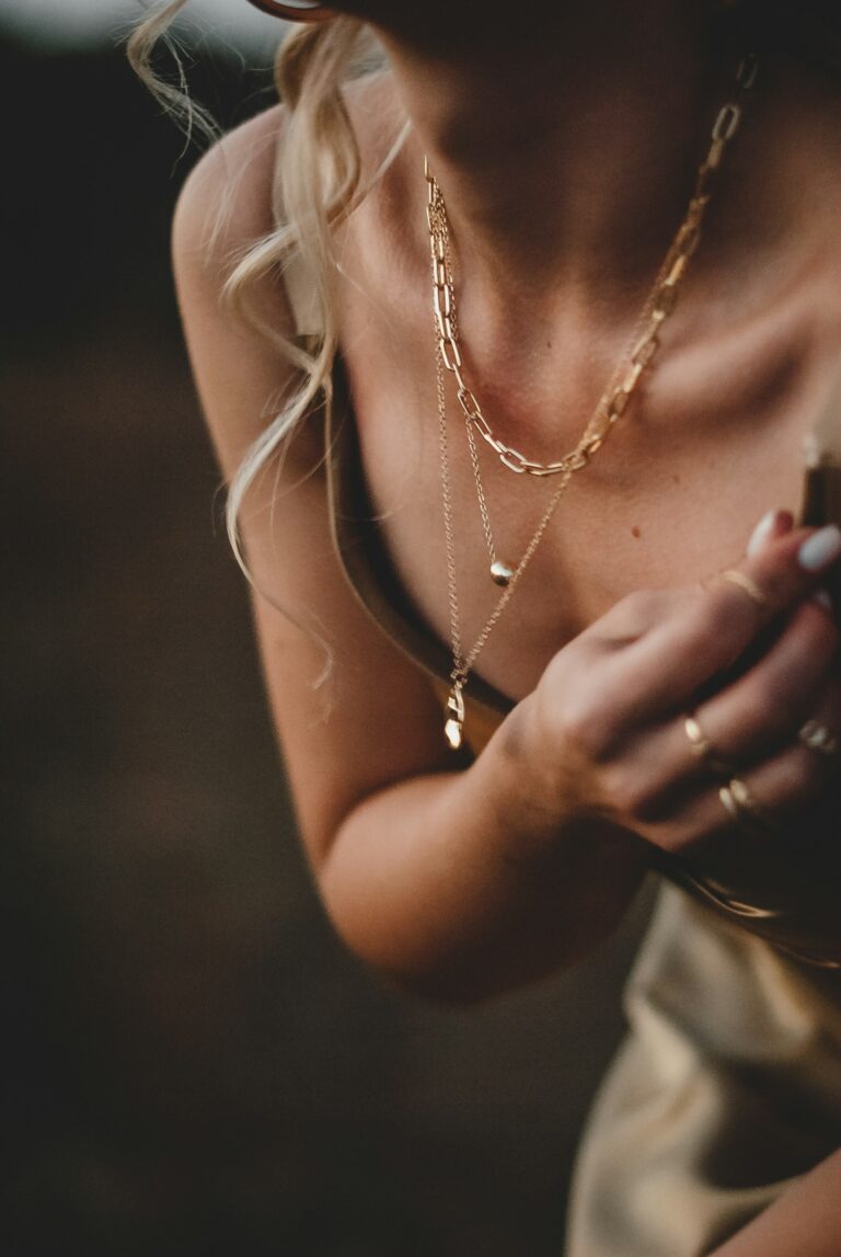 Woman wearing layered dainty necklaces