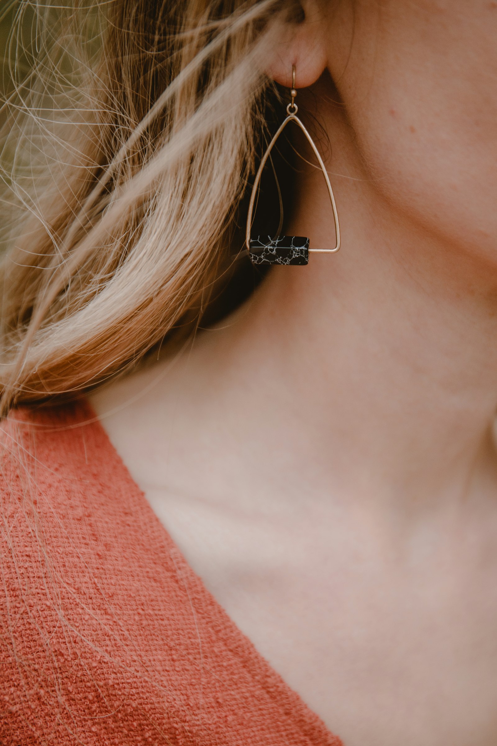 Close-up of a dainty earring on a woman's ear