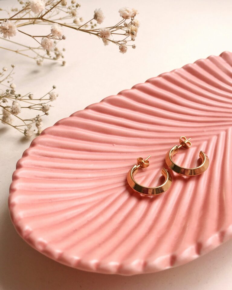 Hoop earrings on a pink jewellery dish, a gift idea for her